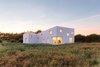 The defining concept for this house, commissioned by a photographer as both his summer house and studio, was based on developed facade studies which define a simple and smooth building skin varied in height and punctured by openings. Photo 2 of House for a Photographer modern home