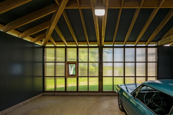 The bronze polycarbonate cladding at the rear of the garage carries around at the clerestory.