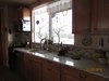 Kitchen area with gas stove, granite counters, dishwasher and huge window to see all the critters Photo 2 of Caliente Creek Ranch modern home