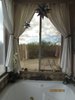 Relaxing hot tub in master bath looking out at the desert Photo 7 of Caliente Creek Ranch modern home