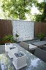 A custom firepit with glass tile, stainless steel counter and stacked stone bring the focus to this patio area. Cooking, dining and seating areas were created to allow for zones when entertaining. Photo 2 of Outdoor Living modern home