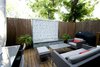 A custom firepit with glass tile, stainless steel counter and stacked stone bring the focus to this patio area. Cooking, dining and seating areas were created to allow for zones when entertaining. Photo 3 of Outdoor Living modern home
