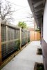 A new living fence was built to hide a rental unit's fence next to this home. When filled in, the living fence provided additional privacy to the homeowner and tenants. Landscape lighting was incorporated into the new fence to aid in security and to provide a peaceful ambiance at night. Photo 5 of Asian Bungalow modern home