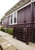 Hardscaping a path to the rental unit enhanced by landscaping brought a warmth to the house that had previously been absent. A new air conditioning screen was built to allow for regular service without being an eyesore for the tenant or the neighbors. Photo 6 of Asian Bungalow modern home