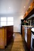 An updated kitchen with plenty of storage and high end finishes set this apartment apart from the competition. The kitchen island was build to be moveable with casters installed underneath the island which allowed greater flexibility for the tenant in the use of the space. Photo 3 of Asian Bungalow - Garden Apartment modern home