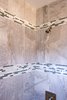 The bathroom was updated with modern finishes, while tile was used in a unique banding stripe to provide interest while saving money. Photo 9 of Asian Bungalow - Garden Apartment modern home