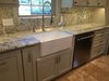 Custom cabinets with specialized functions, granite countertops and solid granite backsplash, hot water dispenser at the sink and a much desired farm sink allowed this kitchen to answer the needs of this family. The double "doors" under the sink is actually a pull-out drawer made to look like doors for ease in retrieving items underneath the sink. Photo 3 of ADA Kitchen modern home