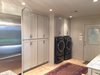 The former laundry room was opened up to the kitchen and allowed for a large pantry and laundry area. The washer and dryer were built into the cabinets with doors that recessed into the sides of the cabinets and allowed them to be hidden away when guests were over. Photo 6 of ADA Kitchen modern home