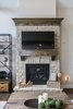 Custom stone fireplace with custom wood beam mantle located in great room Photo 11 of Modified Amelia II Model by DJK Homes modern home