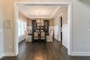 Elegant dining room with custom wainscoting and stepped ceiling detail Photo 15 of Modified Amelia II Model by DJK Homes modern home