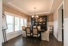 Elegant dining room with custom wainscoting and stepped ceiling detail Photo 14 of Modified Amelia II Model by DJK Homes modern home