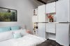 Bedroom with backside of paneled wall that also serves as a closet Photo 13 of J Schatz Studio and Home in Providence modern home