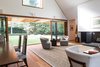 Living Room and Dining Room with lift and slide door open to yard Photo 11 of Gable House modern home