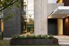 Modern home with Exterior, House Building Type, Flat RoofLine, Concrete Siding Material, Metal Siding Material, and Stone Siding Material. Taula House by M Gooden Design | Entry Photo 2 of Taula House