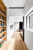 Modern home with Hallway and Light Hardwood Floor. Taula House by M Gooden Design | Landing Photo 3 of Taula House