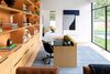 Modern home with Office, Library Room Type, Desk, Shelves, Chair, Study Room Type, and Light Hardwood Floor. The serene home office of Taula House by M Gooden Design gazes out onto the backyard. Photo 7 of Taula House