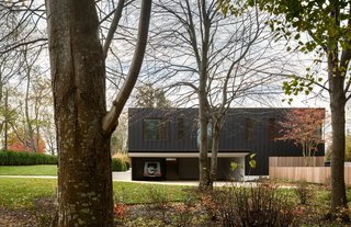 A carport is tucked under one of the home's elevated wings.