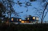 Rear of the house at dusk. Photo 14 of Watermill House modern home