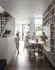 Modern home with Living Room, Bench, Chair, Bookcase, Ceiling Lighting, Wall Lighting, Dark Hardwood Floor, and Wood Burning Fireplace. Dining Room Photo 11 of Brooklyn Row 1