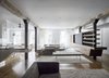 Modern home with Living Room, Bookcase, Sectional, End Tables, Bench, Medium Hardwood Floor, and Sofa. East View Photo of Tribeca Loft