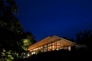 Atop a ridge in the Santa Lucia Preserve, Halls Ridge Knoll guest house takes advantage of passive design opportunities in its temperate climate. Expansive windows provide natural lighting throughout, while a broad overhang shades interiors from the summer sun. Sliding doors and operable windows use the prevailing winds for natural ventilation, and provide expansive views of the surrounding mountain range. 