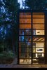 Floors are concrete on the lower level and exposed wood car decking is used on the upper floor. Photo 6 of Lightbox modern home