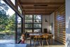Shelving is crafted from resawn timbers and much of the furniture and fixtures were found during the Owner's travels, such as the antique Pittsburgh Mercury Lamp hanging in the Dining Area. Photo 9 of Lightbox modern home