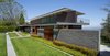 Modern home with Outdoor, Shrubs, Stone Fences, Wall, Grass, Horizontal Fences, Wall, and Front Yard. After renovation Photo 4 of Council Crest Residence
