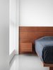 Wood and fabric are selected to punctuate the space and to provide warmth and intimacy. Photo 6 of The Element Apartment modern home