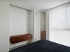 Doors are set not only to divide rooms but to unite space; when opened, the full height panels disappear and make the entire unit one continuous whole. Photo 4 of The Element Apartment modern home