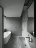 A cave-like master bathroom in response to the natural surrounding of the outside. Photo 11 of H Residence modern home
