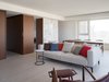 Modern home with Living Room, Light Hardwood Floor, Recessed Lighting, Chair, and Sofa. Stone and wood veneer block define the space without separate it. Photo 2 of W Residence