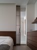 Modern home with Bedroom, Light Hardwood Floor, Recessed Lighting, Dresser, Bed, and Shelves. A glimpse of master bathroom from the entrance. Photo 9 of W Residence