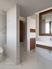 Modern home with Bath Room, Engineered Quartz Counter, One Piece Toilet, Drop In Sink, Light Hardwood Floor, Recessed Lighting, and Ceramic Tile Wall. Master bathroom. Photo 10 of W Residence