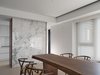 Modern home with Light Hardwood Floor, Chair, and Recessed Lighting. Dinning space and kitchen defined by a storage unit with stone facade. Photo 14 of W Residence