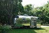 Gogo, Exterior / Polished metal offset by black accents. The look mimics some of the jewelry created inside; polished dark stones set in silver pendants. Photo 4 of Gogo, the 1974 Argosy modern home