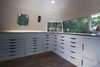 Modern home with Shed & Studio. Gogo, Showroom / Ikea units were integrated into the curved space with custom built-ins. They include a hidden utility box and sound system, open display cases, and a narrow planter. Photo 5 of Gogo, the 1974 Argosy