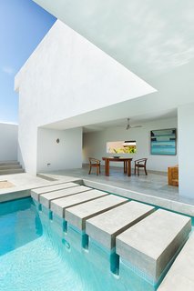 Designed by Campos Leckie to invoke a pure, dream-like quality, this minimalist retreat is situated on a hill above Zippers Beach overlooking the Sea of Cortez. The bold geometric angles, stripped down interior, and whitewashed walls allow for maximum light and shadow play throughout the day. The home features a zen garden, central pool, and a rooftop patio with sweeping views of the ocean and mountains.