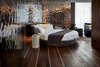Modern home with Bedroom, Dark Hardwood Floor, and Bed. Elegant blues, grays, and ample natural light work together to create a luxury seaside resort atmosphere, while rich textural elements and vibrant decor accents highlight Ibiza's tradition as an epicenter of decadent club life. Photo 8 of Sir Joan Hotel