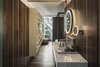 Modern home with Bath Room, Wall Mount Sink, Marble Counter, and Dark Hardwood Floor. The design team embraced Ibiza's upscale club culture when designing the hotel's two signature restaurants, the modern Asian cuisine-based Izakaya and The Butcher, an upscale seasonal "burger joint." Photo 10 of Sir Joan Hotel