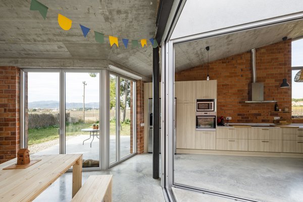 Organic warmth is achieved from the use of exposed materials throughout the home, specifically ceramic, concrete, and wood.