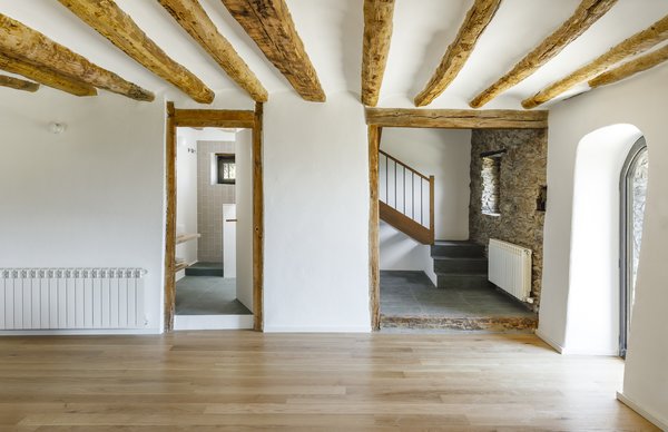 The updated entrance to the farmhouse features a renovated staircase and guest bathroom. 