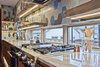 Living Edge floating shelves harvested from local beetle killed pine trees. Then sawn, sanded, and filled with black epoxy wood filler accents and harbor mist stain. A routed channel is created to embed LED lighting. Photo 5 of Modern Barn Revival modern home