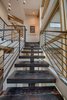 Custom ironwork blackened and polished mono-rail stair stringer. Floating solid Doug Fir treads that are wire brushed and have same Shou Sugi Ban technique as the floors. Photo 6 of Modern Barn Revival modern home