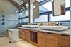 Master bath includes spacious walk-in shower and tub. Floating mirrors allow for natural lighting and great views to complement this space. Photo 9 of Modern Barn Revival modern home