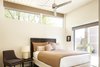 Modern home with Bedroom, Track Lighting, Bed, Wardrobe, Chair, Storage, Table Lighting, Carpet Floor, and Night Stands. Tan Queen Bedroom Photo 11 of Waters Edge. Private Meiselman Mid-Century Modern with Views and Stunning Saltwater Pool