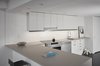 Modern home with Kitchen, White Cabinet, Ceramic Tile Backsplashe, Engineered Quartz Counter, Vinyl Floor, Recessed Lighting, and Drop In Sink. View of Kitchen From Living Area Photo 9 of MC01