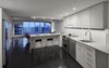 Modern home with Kitchen, Engineered Quartz Counter, Subway Tile Backsplashe, White Cabinet, Vinyl Floor, Recessed Lighting, Drop In Sink, and Ceramic Tile Backsplashe. View Through Unit from Entry Photo 8 of MC01