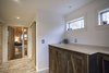 The bricks in the underfloor heated hallway came from an old chimney previously attached to the back of the building which had to be dismantled. Old barn board and new maple are used in partnership for the doors. Photo 5 of The Bath House modern home
