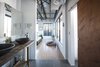 Master vanity made from 200 year old butcher table, sliding wood door separates WC, slate tile throughout tub room and shower
. Photo 7 of Studio GoodLight modern home